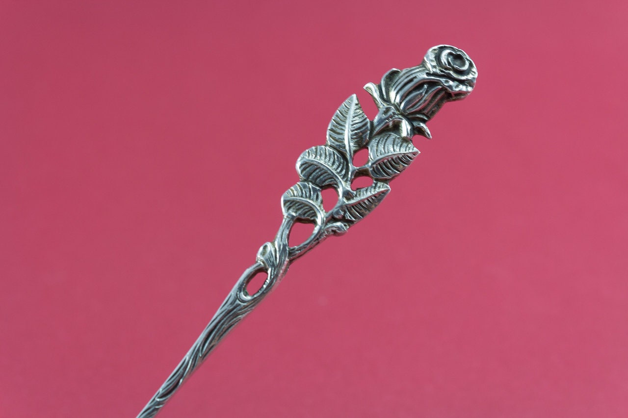 Zuckerlöffel mit einem Rosenmuster aus 800er Silber