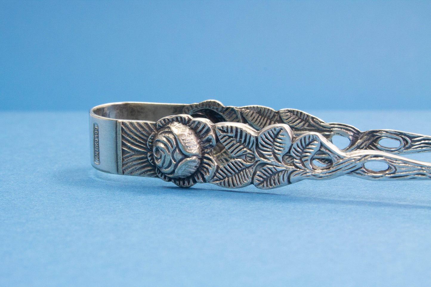 Silver plated sugar tongs with roses