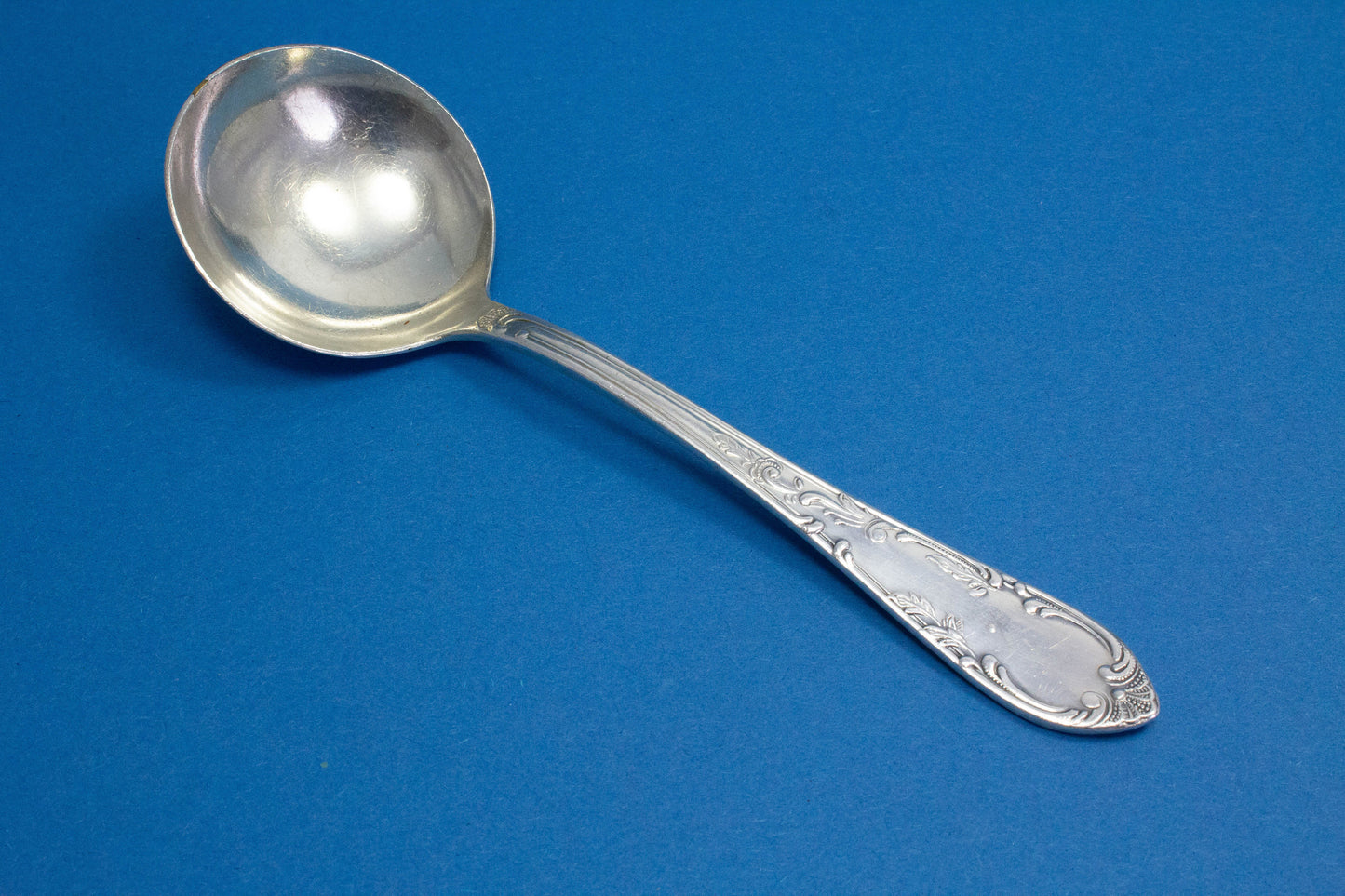 Silver-plated cream spoon with rococo decorations