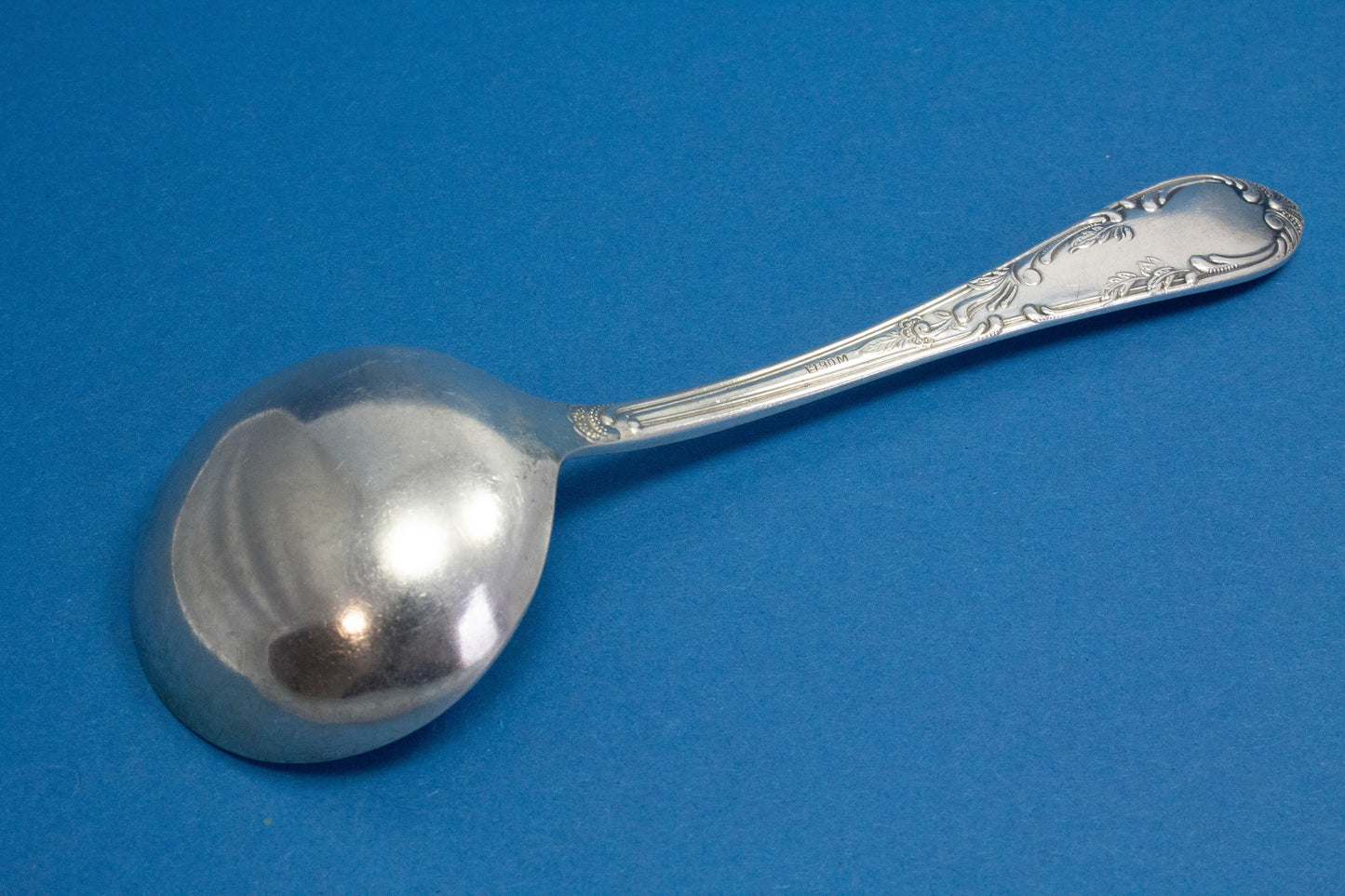 Silver-plated cream spoon with rococo decorations