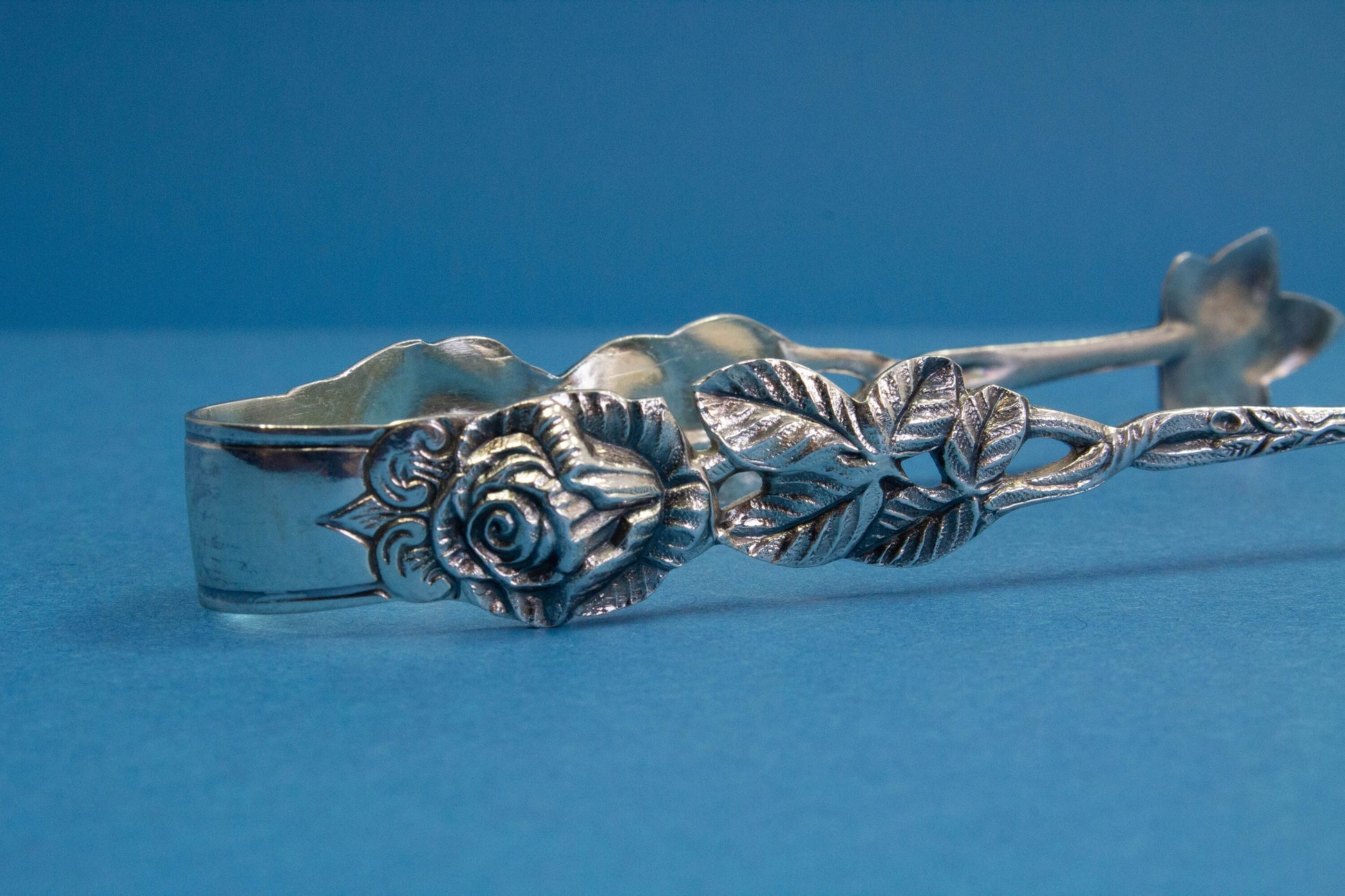 Silver plated sugar tongs with roses